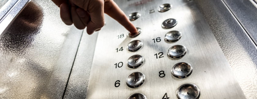 Person pressing an elevator button.