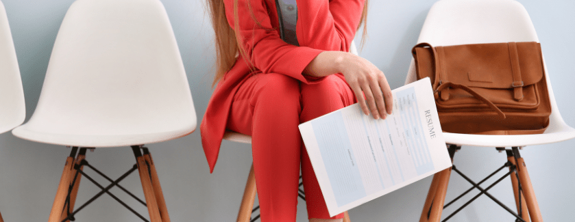 Person sitting with resume in hand.